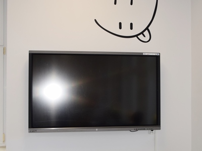 Napis "Be happy" na ścianie sali językowej