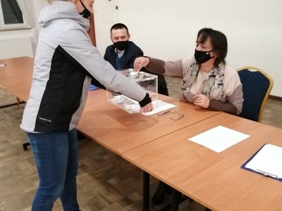 Kobieta z urną zbiera głosy oddane na Sołtysa Pieńkówka
