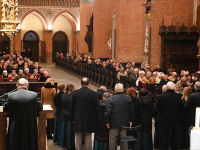 Grupa osób w Bazylice Katedralnej w Pelplinie podczas koncertu. Wewnątrz.