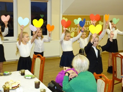Zdjęcie przedstawia dzieci, które tańczą laurkowy taniec dla dziadków.