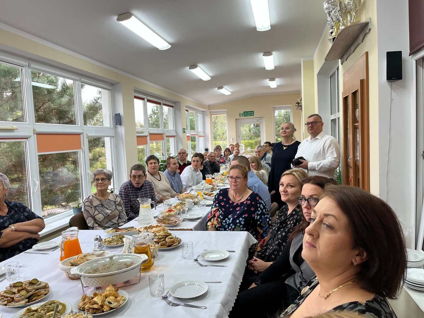 na zdjęciu podopieczni Powiatowego Domu Samopomocy w Węgorzewie siedzący przy stole