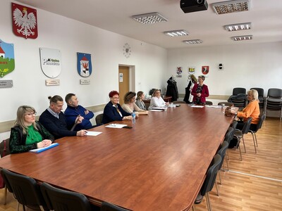 członkowie Rady Działalności Pożytku Publicznego Powiatu Węgorzewskiego siedzą przy stole w sali konferencyjnej - trwają obrady 