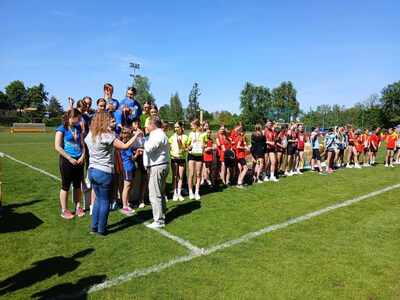 wręczenie nagród na podium stoją zawodnicy, którzy zajęli miejsca 1-3, w tle reszta uczestników igrzysk
