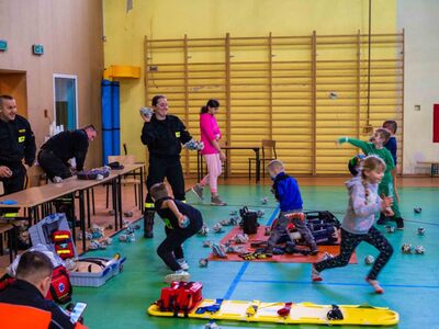 Uczestnicy imprezy "Bezpieczne ferie 2024" przy stoisku strażaków