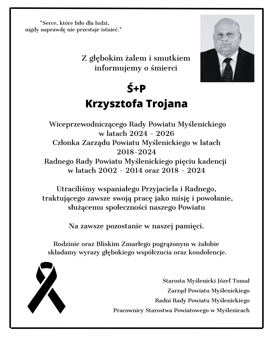 Czarno-biała klepsydra żałobna z portretem Ś.P. Krzysztofa Trojana oraz informacją o jego śmierci i pełnionych funkcjach samorządowych.