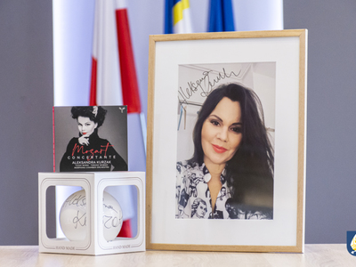 Zestaw autografów (plakat, płyta i bombka) Aleksandra Kurzak.
Aleksandry Kurzak – solistka operowa związana m.in. z Metropolitan Opera w Nowym Jorku,  Covent Garden w Londynie i Wiedeńską Operą Narodową.  