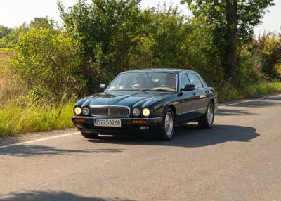 Zabytkowy samochód i uczestnicy rajdu