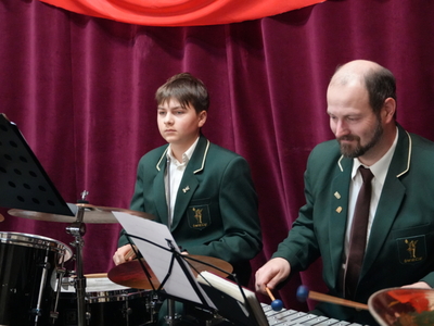 Koncert z okazji 106 rocznicy odzyskania przez Polskę Niepodległości. Muzycy w zielonych marynarkach orkiestry dętej podczas występu