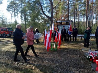 Święto Żołnierzy Niezłomnych w Lipinkach. Składanie kwiatów pod pomnikiem, strażacy i poczty sztandarowe w tle, symboliczne upamiętnienie poległych.