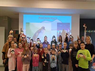 Ferie zimowe 2024, dzieci na tle ekranu z projekcją Pingwin Mały
