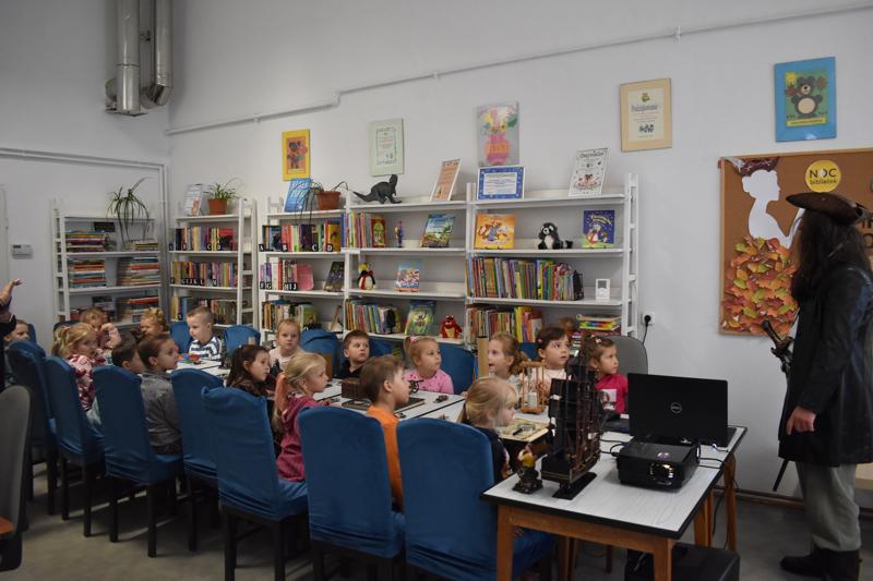 Przedszkolaki z grupy pięciolatków podczas słuchania opowieści pirata