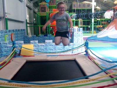 Zdjęcie przedstawia wychowankę Placówki Wsparcia Dziennego w Laskach na trampolinie.