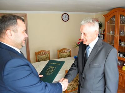  Zdjęcie przedstawia wójta Radosława Nowakowskiego wręczającego list gratulacyjny Jubilatowi Stanisławowi Struzik z Niemicy z okazji 90-tych urodzin. 