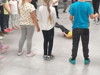 Zdjęcie przedstawia dzieci uczestniczące w zajęciach breakdance w Świetlicy Kultury w Malechowie. 