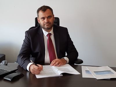 Wójt Gminy Malechowo -Radosław Nowakowski przy biurku w swoim gabinecie.
