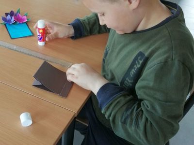 Wychowanek świetlicy w Kusicach podczas przygotowania kartki dla mamy.