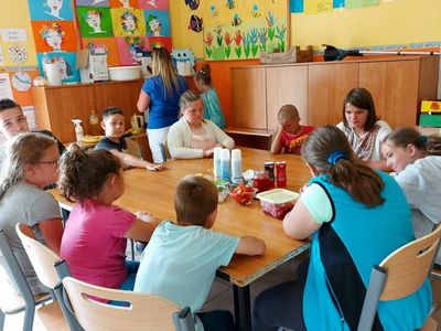 Wychowankowie z Placówki Wsparcia Dziennego w Laskach, którzy jedzą naleśniki.