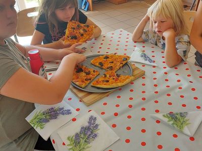Wspólna degustacja pizzy dzieci z Placówki Wsparcia Dziennego w Laskach.
