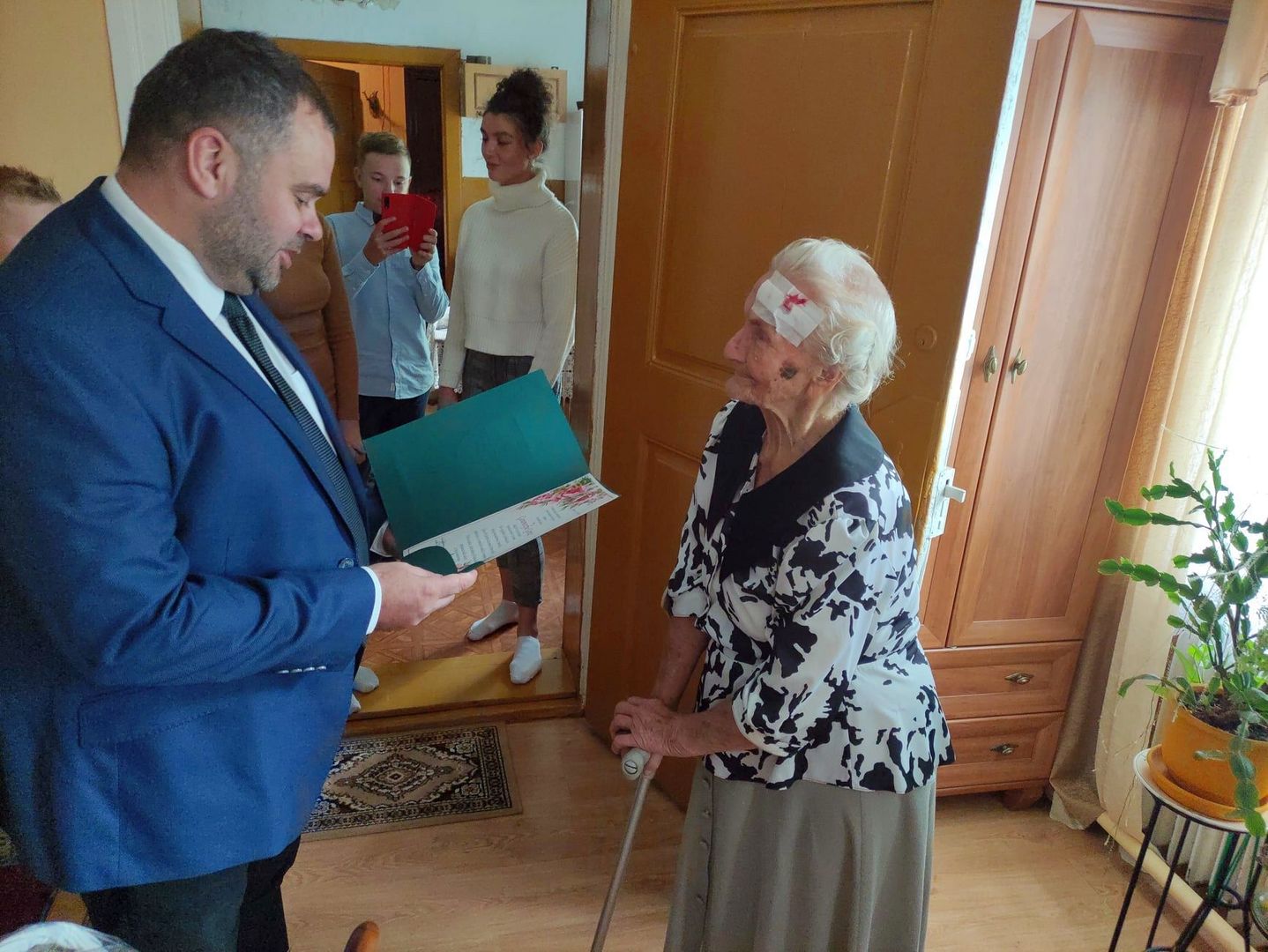 Wójt Radosław Nowakowski odczytuje oficjalny list gratulacyjny 95-letniej Genowefie Góraj.