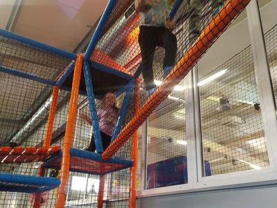 Dzieci z Placówki Wsparcia Dziennego z Lasek pokonują tor przeszkód w Parku Trampolin w Koszalinie.