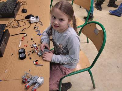Wychowanka Świetlicy Kultury w Malechowie podczas składania elementów minirobota. 