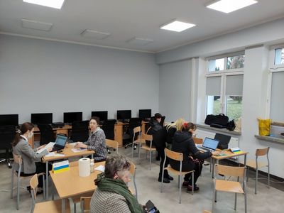 Obywatele Ukrainy podczas wypełniania dokumentów przy pomocy pracownic ZUS.