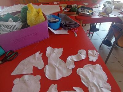 Wychowanek z Placówki Wsparcia Dziennego z Lasek szyje maskotkę.
