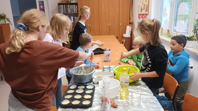 Wychowankowie Placówki Wsparcia Dziennego z Ostrowca podczas przygotowywania muffinek.