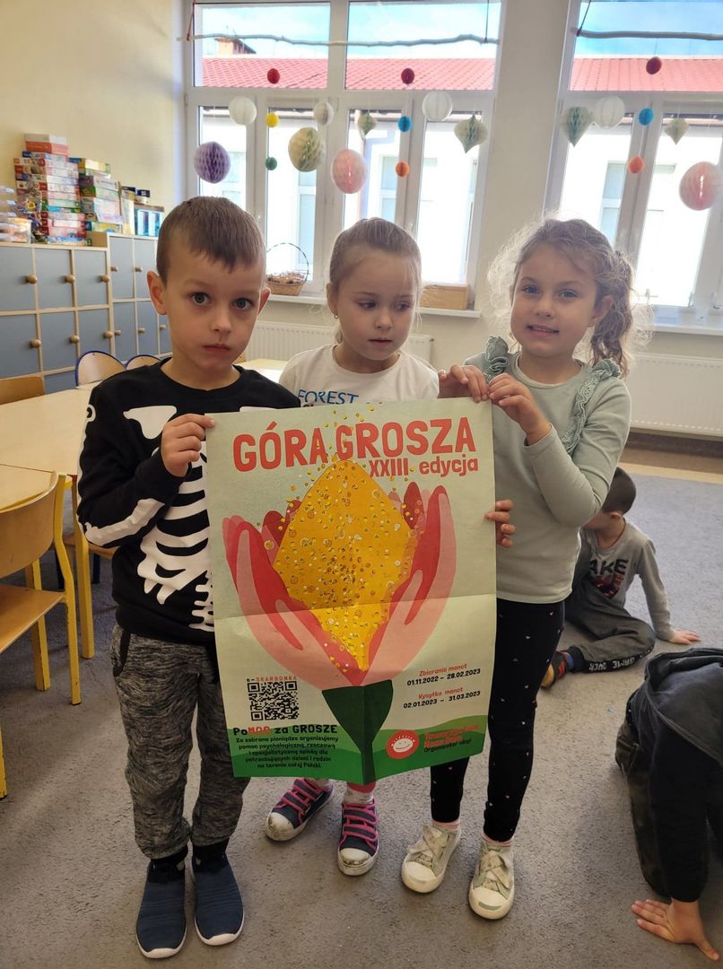 Dzieci z oddziału przedszkolnego ze Szkoły Podstawowej w Niemicy prezentują plakat akcji „Góra Grosza”.