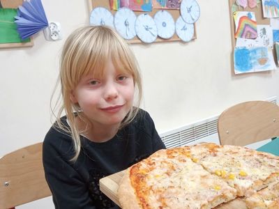 Zosia z Placówki Wsparcia Dziennego w Niemicy pokazuje swoją pizzę.