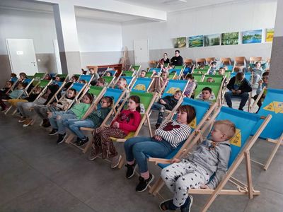 Zdjęcie dzieci ze szkoły w Malechowie na leżakach podczas projekcji filmu.