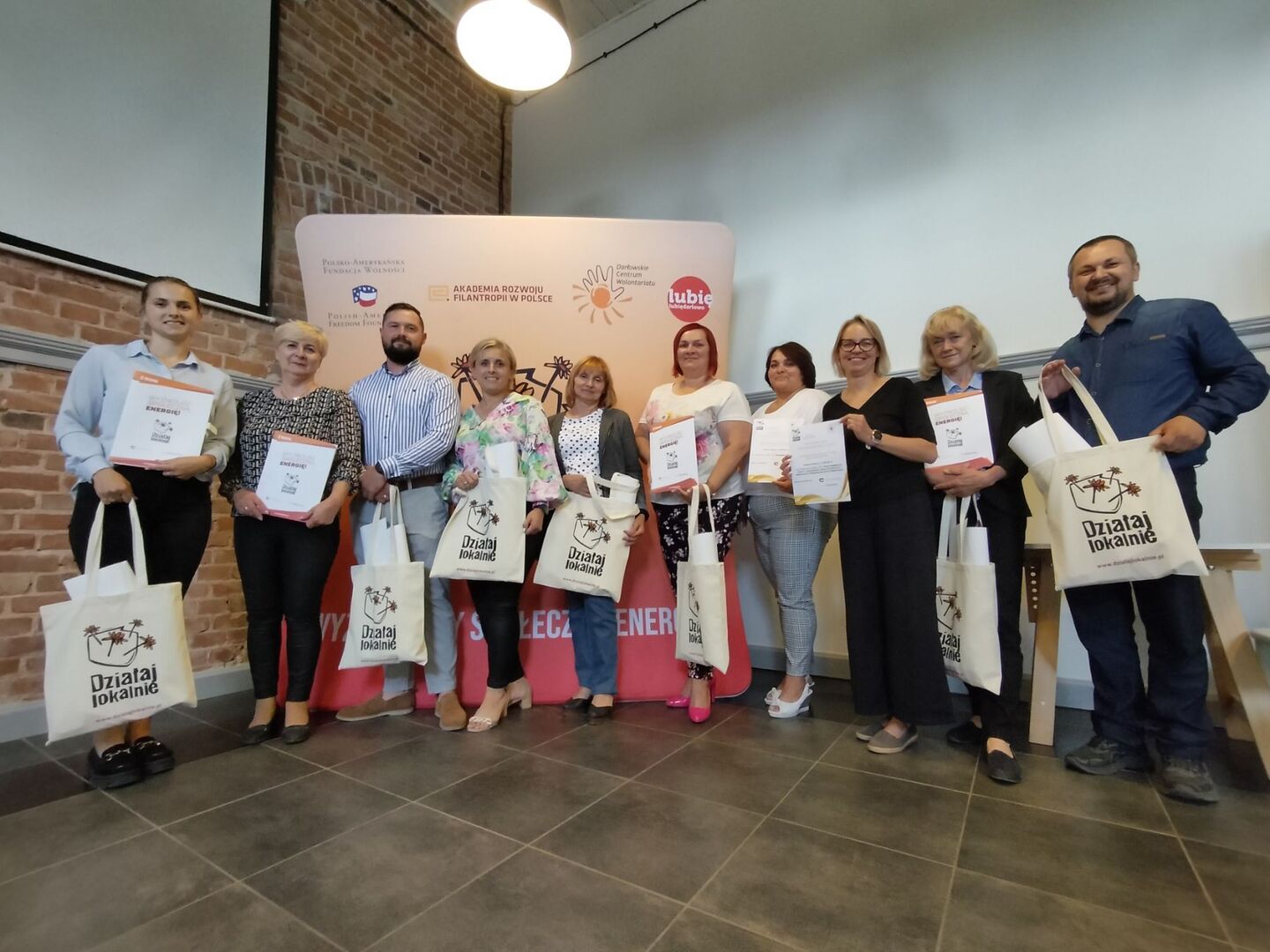 Beneficjenci programu "Działaj Lokalnie" pozują do wspólnego zdjęcia.