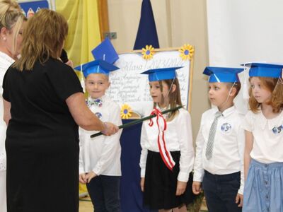 Pani dyrektor z wychowawcą w trakcie pasowania na ucznia.