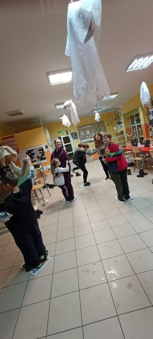 Dzieci podczas zabawy tanecznej na gazetach.