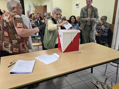 Uczestnicy zebrania wiejskiego na świetlicy w Karwicach wrzucają karty głosowania do urny wyborczej.