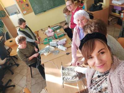 Na zdjęciu 6 osób, zaplatają makramę,