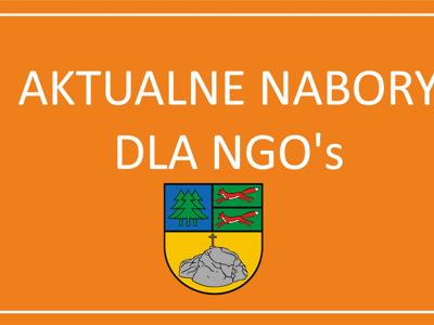 pomarańczowe tło z napisem aktualne nabory dla NGO's Z HERBEM gMINY tYCHOWO