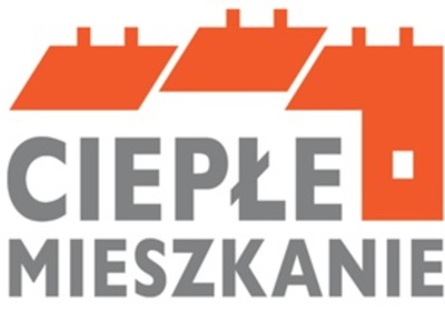 Na zdjęciu widać kontury budynków oraz napis ciepłe mieszkanie
