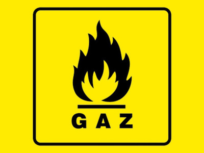 Na zdjęciu widnieje znak informujący o gazie na żółtym tle.